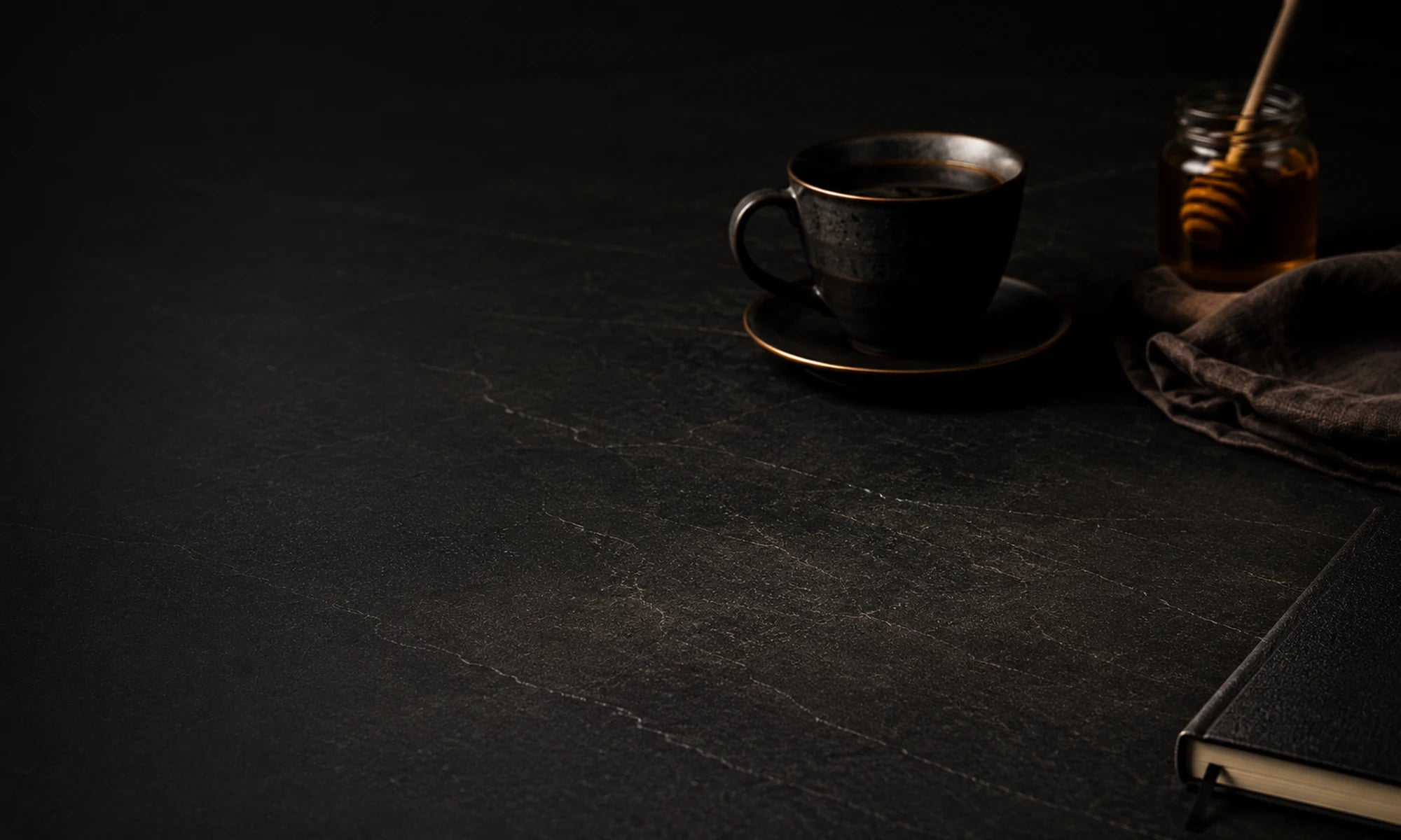 A quiet morning setting with coffee, honey, and a notebook